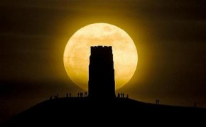 Revellers stand beside St. Michael's Tower on Glastonbury Tor watching the moon as it is at its closest point to the Earth for almost two decades.Photo Credit: The Telegraph