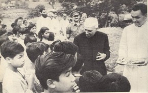 Nehru distributing sweets to children