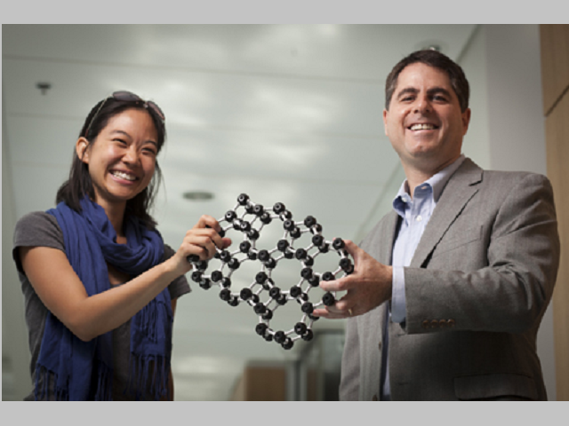 Graduate student Pinshane Huang and Professor David Muller with a model that depicts the atomic structure of glass.