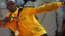 Usain Bolt celebrates winning his third gold
