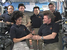 Gennady Padalka ceremonially hands control of the International Space Station to Suni Williams. PhotoCredit: NASA TV