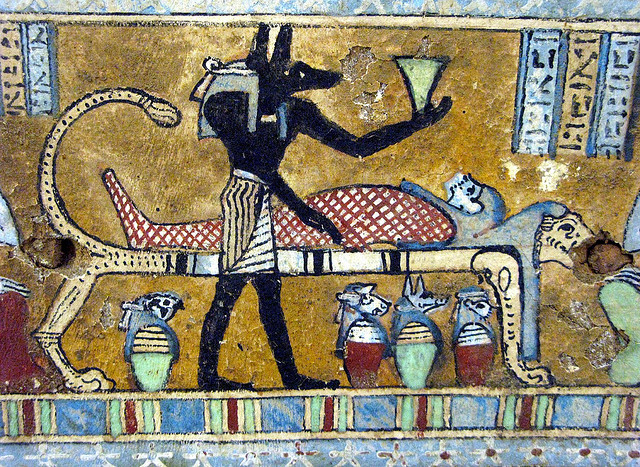 Priest with a jackal mask doing mummification in ancient Egypt